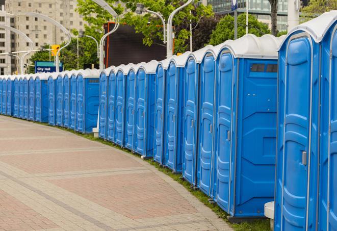 hygienic portable restrooms lined up at a music festival, providing comfort and convenience for attendees in Austell GA